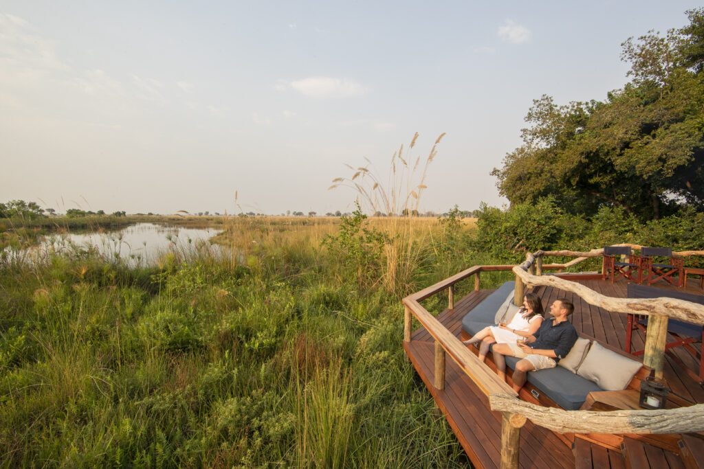 Guests enjoying the view from the deck at Shinde, Botswana | Photo credit: Shinde