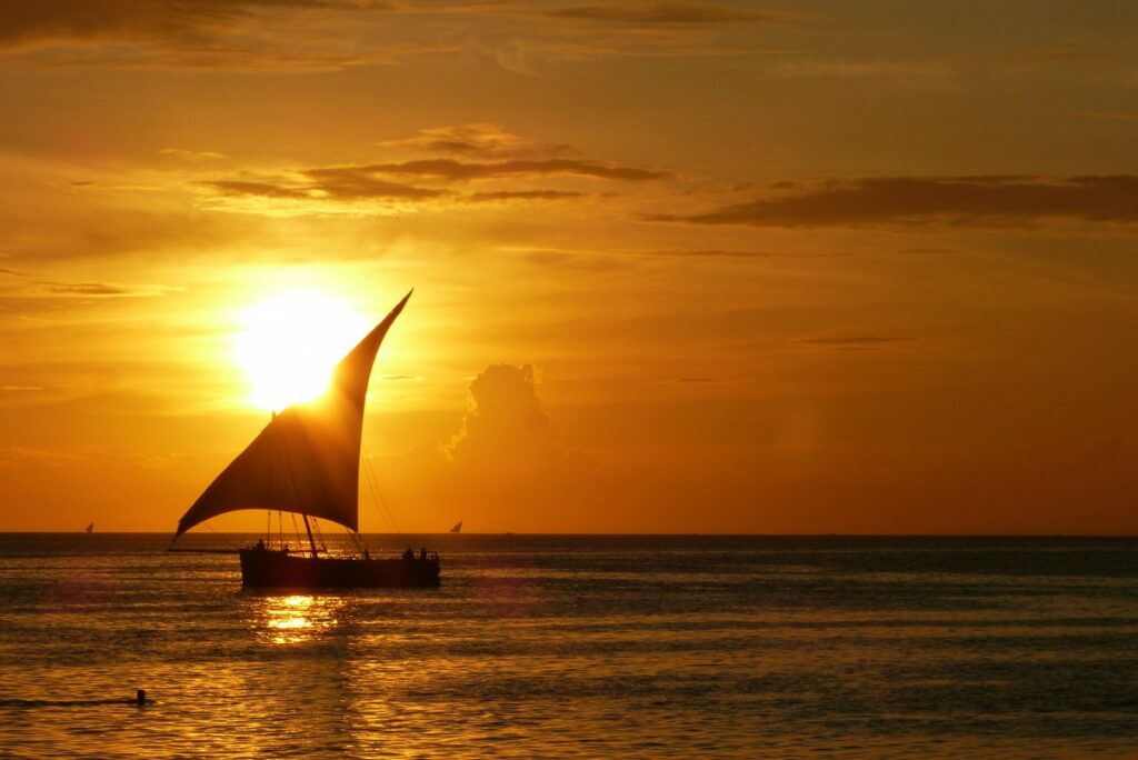 Boat sailing in sunset near Stone Town, Zanzibar.