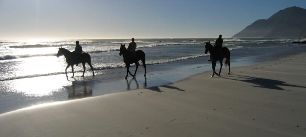 Horse riders on Noordhoek beach in Cape Town.