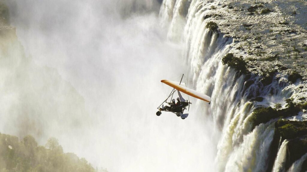 Microlight flies above Victoria Falls.