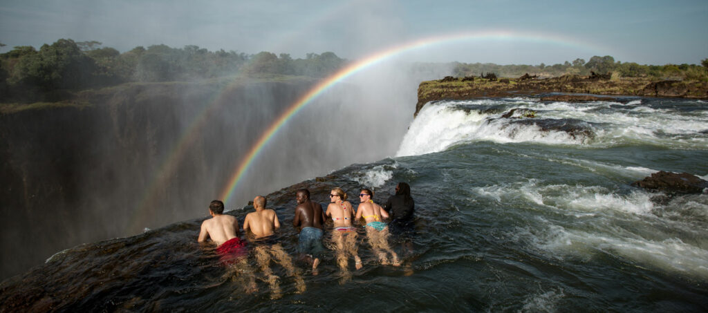 Tourists on the edge of Devil's Pools in Victoria Falls.