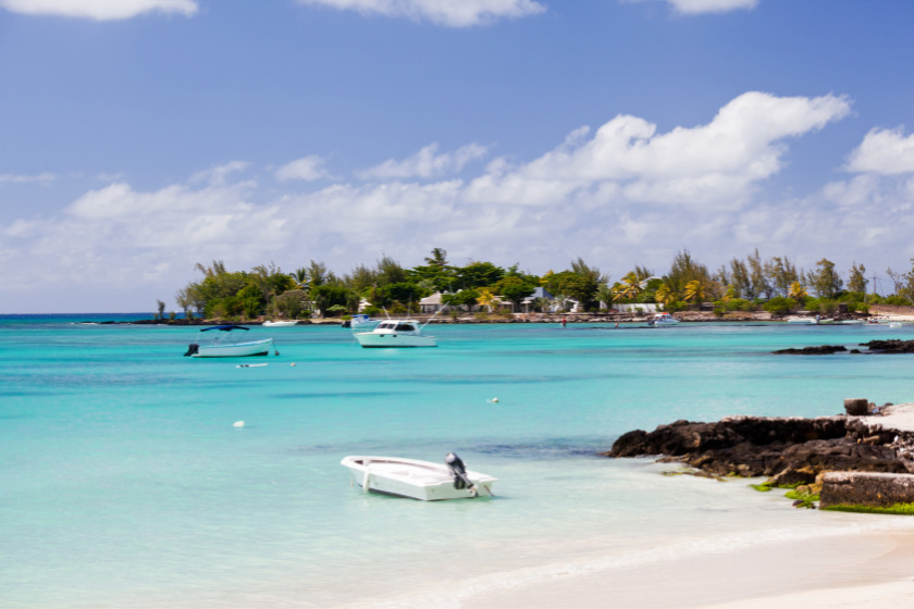 A few boats in the water at Pereybere Beach, Mauritius