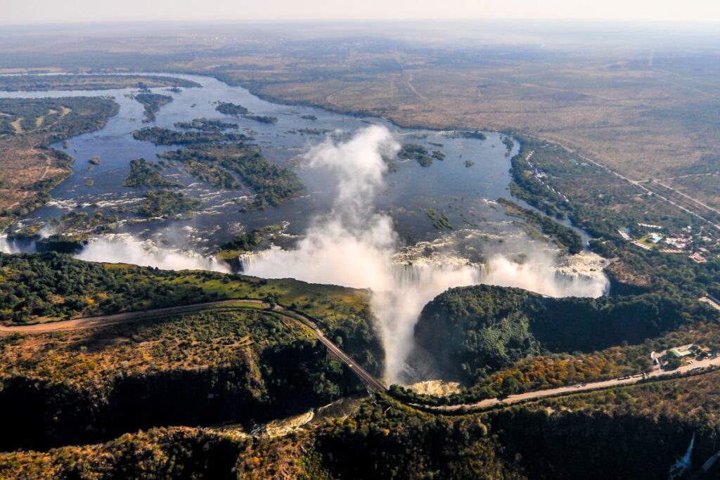 Train tracks pass over a waterfall in Zambia.