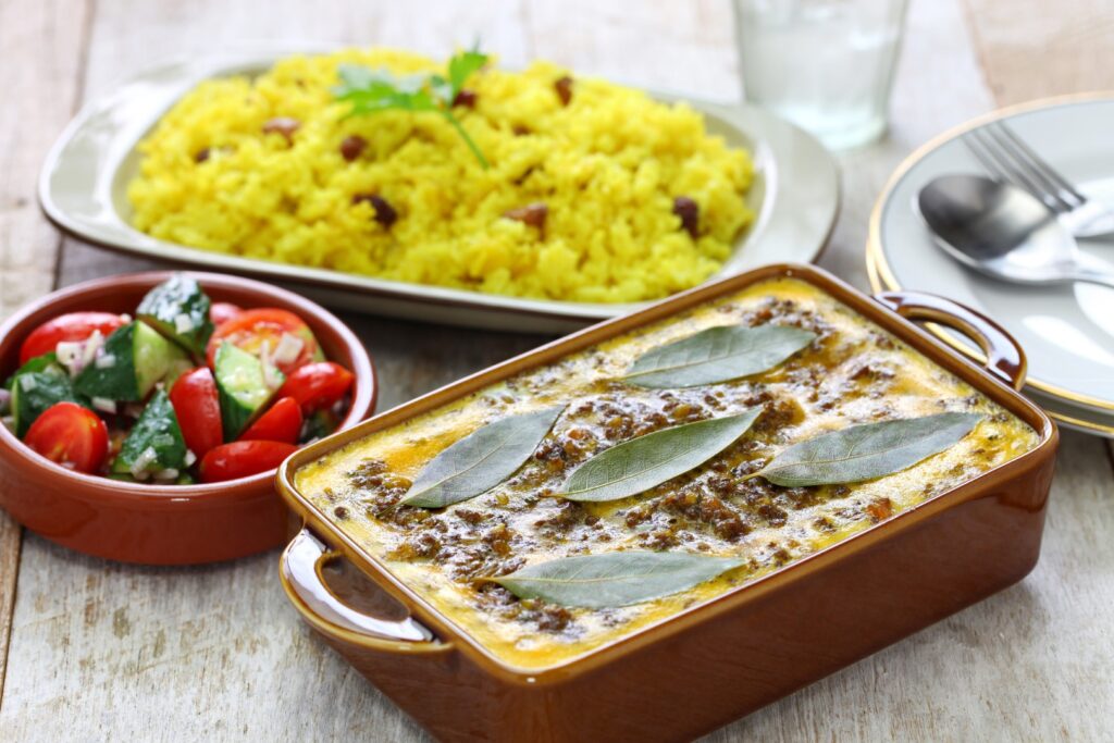 Bobotie with some yellow rice served with a salad. Photo: Getty Images