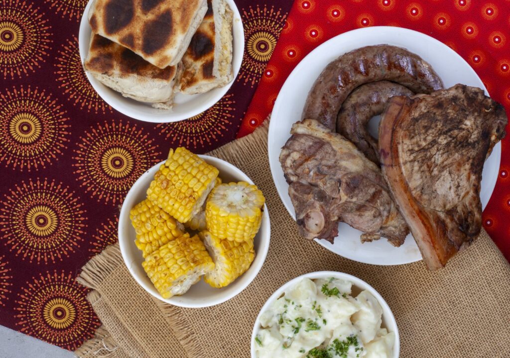 Spread of a typical braai with meat, braaibroodjies and corn. Photo: Getty Images