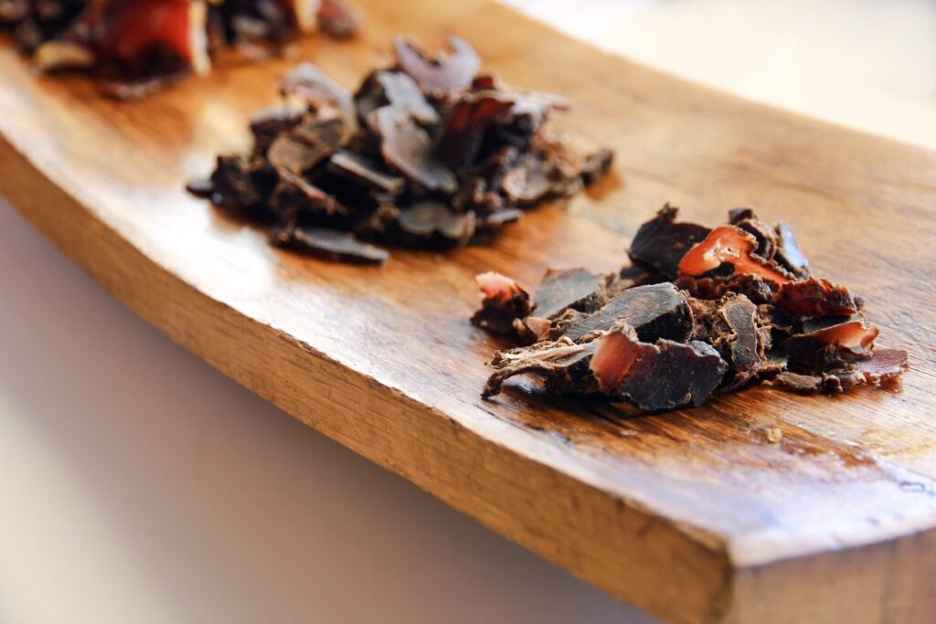 Three different types of biltong on a wooden platter. Photo: Getty Images