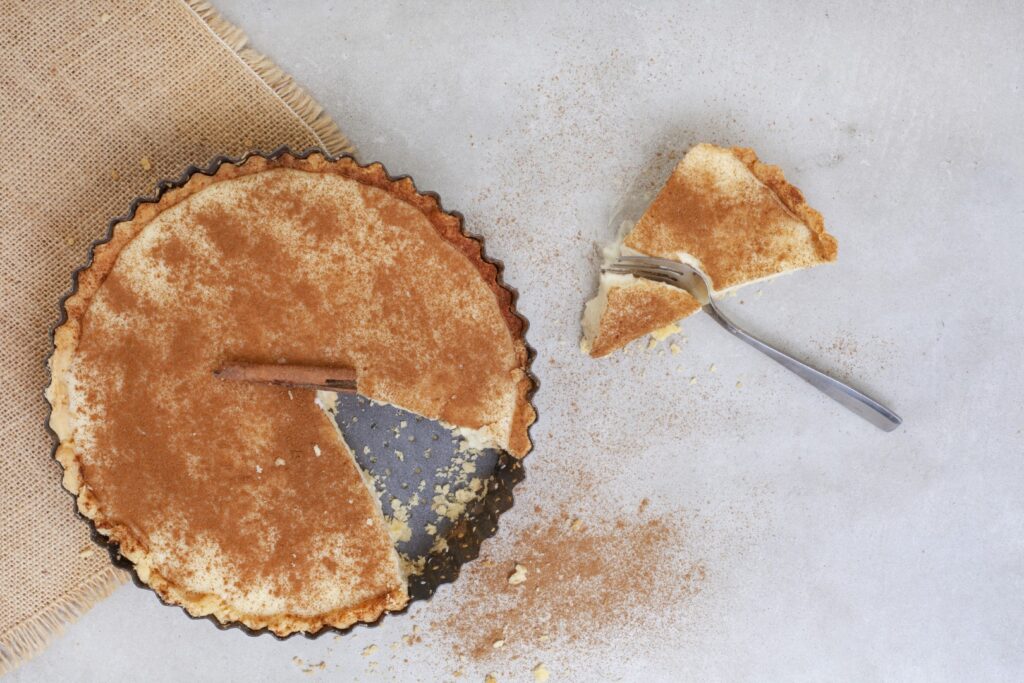 Traditional South African milk tart freshly baked and in tin. Photo: Getty Images